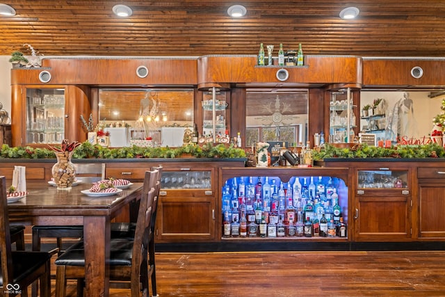 bar with dark hardwood / wood-style flooring and wood ceiling