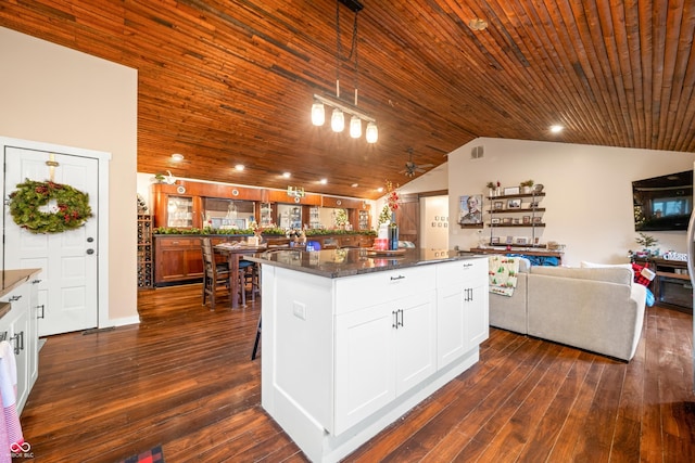 kitchen with pendant lighting, a center island, white cabinets, ceiling fan, and dark hardwood / wood-style flooring