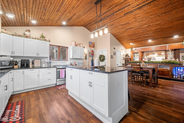 kitchen with wooden ceiling, hanging light fixtures, appliances with stainless steel finishes, tasteful backsplash, and white cabinetry