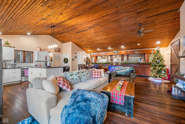 living room with wood ceiling, ceiling fan with notable chandelier, dark wood-type flooring, a barn door, and high vaulted ceiling