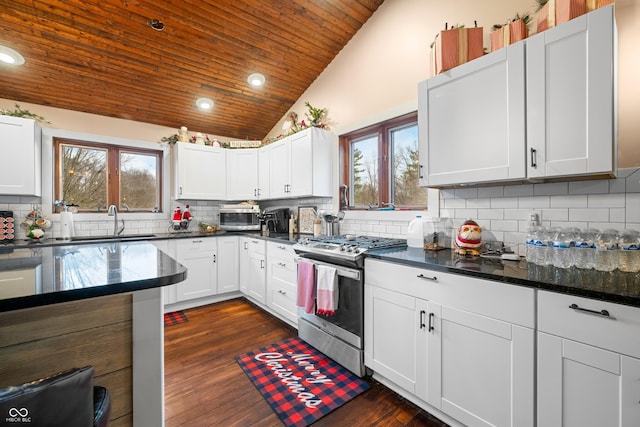 kitchen with white cabinets, appliances with stainless steel finishes, lofted ceiling, and sink