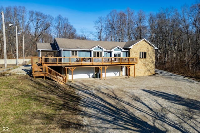 view of front of property featuring a garage and a deck