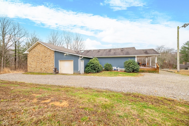 view of front of home with a wooden deck and a garage