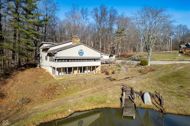 exterior space with a boat dock and a water view