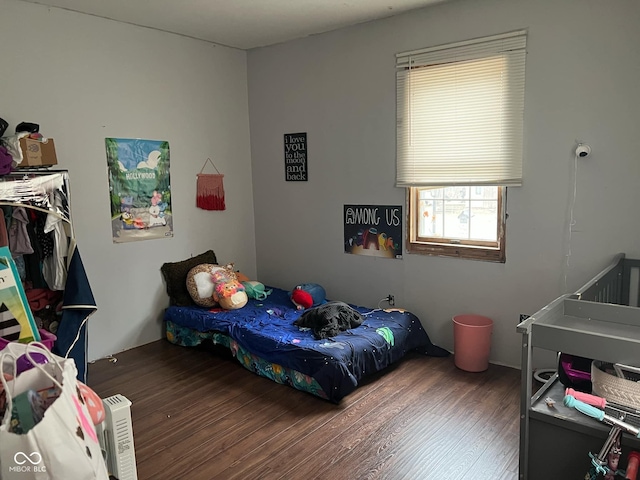 bedroom featuring dark hardwood / wood-style flooring