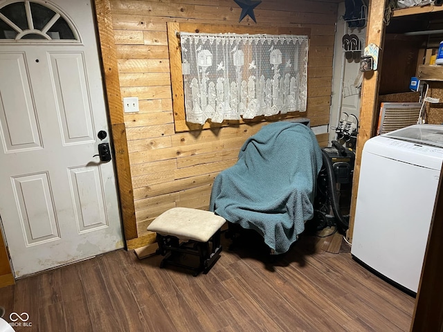 laundry area featuring wood-type flooring, washer / clothes dryer, and wood walls