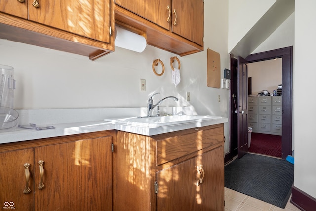 kitchen with sink and light tile patterned flooring