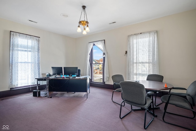 office with carpet and a chandelier