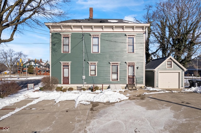 italianate house featuring an outbuilding and a garage