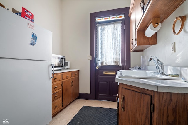 kitchen with sink and white fridge