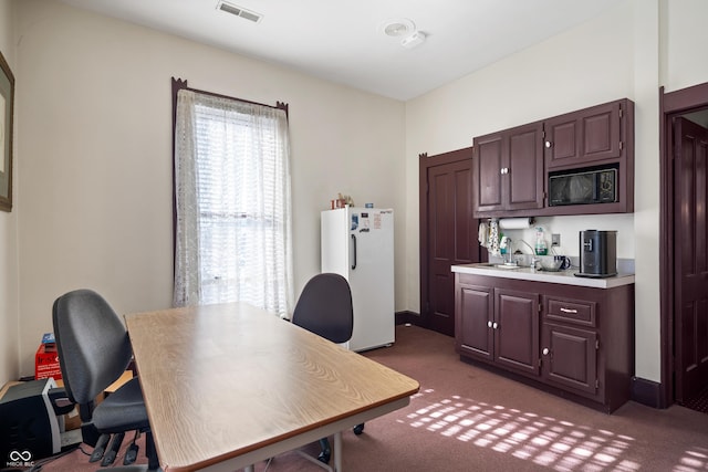 office space with dark carpet and sink