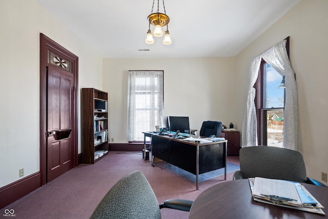 home office with carpet flooring and an inviting chandelier