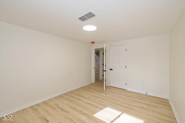 spare room featuring light hardwood / wood-style floors