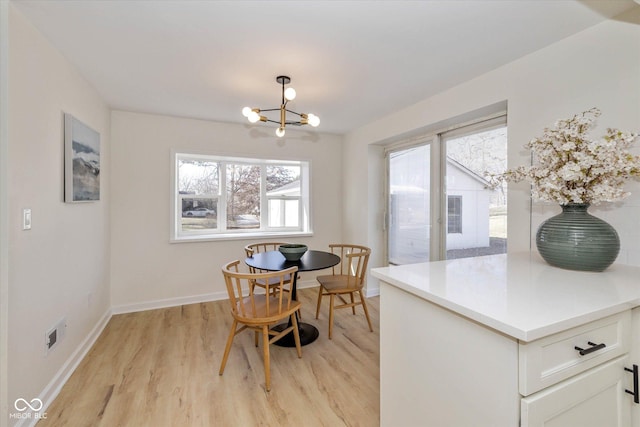 dining area featuring a chandelier and light wood-type flooring