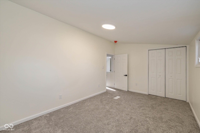 unfurnished bedroom featuring carpet flooring and a closet