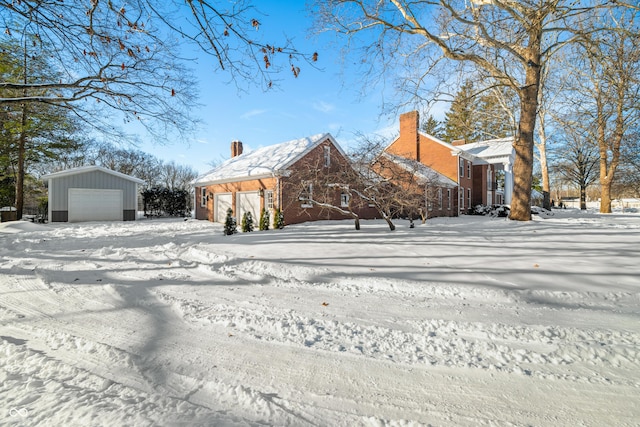 view of front of property featuring a garage and an outbuilding