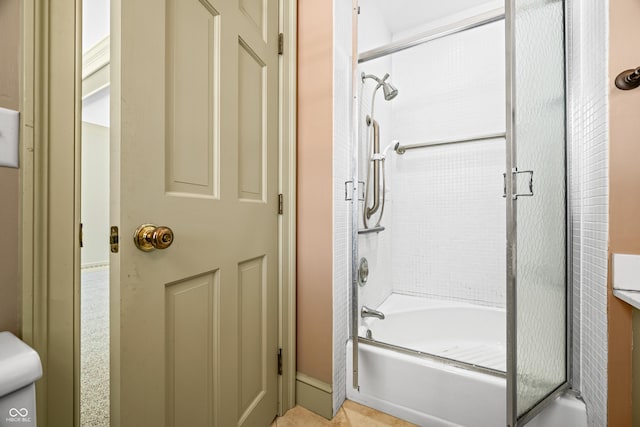 bathroom featuring combined bath / shower with glass door