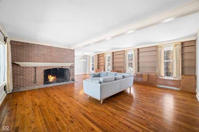 unfurnished living room with a fireplace, wood-type flooring, and crown molding