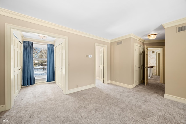 spare room featuring light colored carpet and ornamental molding