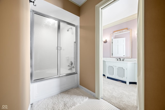 bathroom with combined bath / shower with glass door and sink