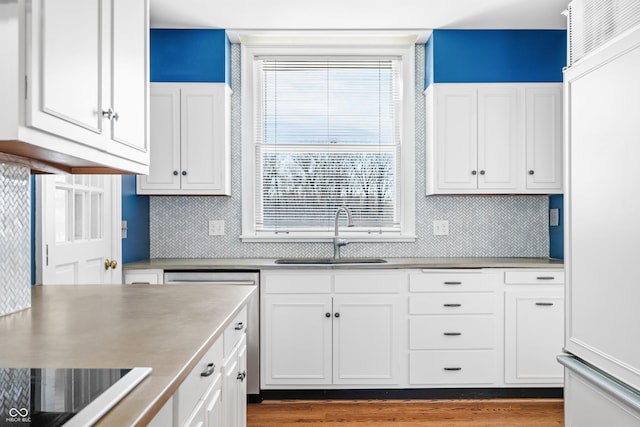 kitchen with white cabinets, black electric cooktop, and sink