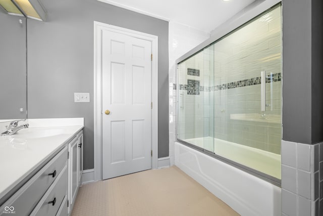 bathroom with tile patterned floors, vanity, and shower / bath combination with glass door