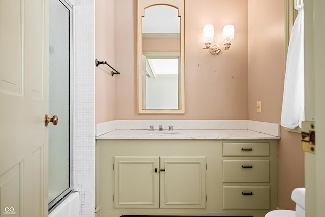 full bathroom featuring shower / bath combination with glass door, vanity, and toilet