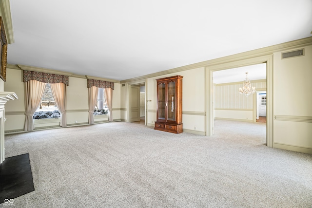 unfurnished living room featuring carpet flooring, crown molding, a premium fireplace, and a notable chandelier