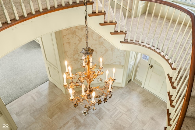 interior space featuring carpet flooring and a notable chandelier