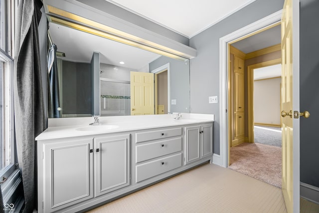 bathroom with vanity, an enclosed shower, and ornamental molding