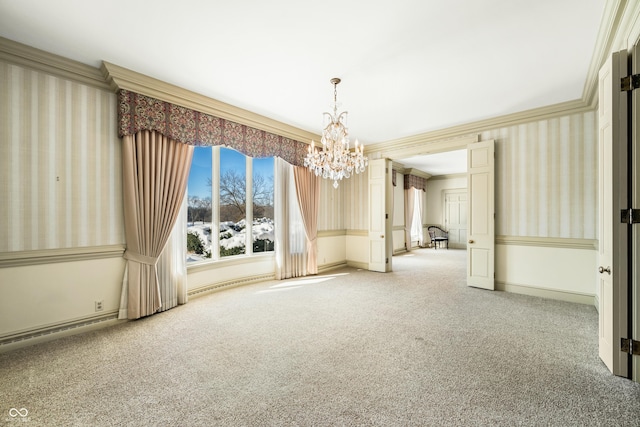 spare room featuring carpet, a baseboard heating unit, an inviting chandelier, and crown molding