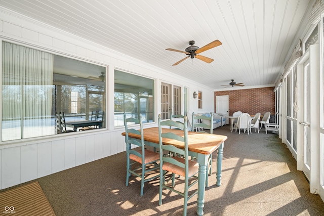 sunroom with ceiling fan and wooden ceiling