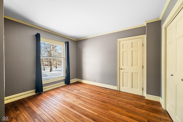 unfurnished bedroom featuring a closet, crown molding, and hardwood / wood-style floors