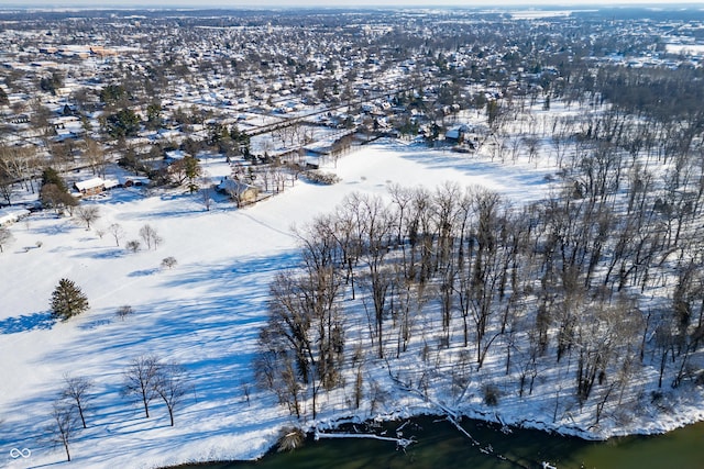 snowy aerial view featuring a water view