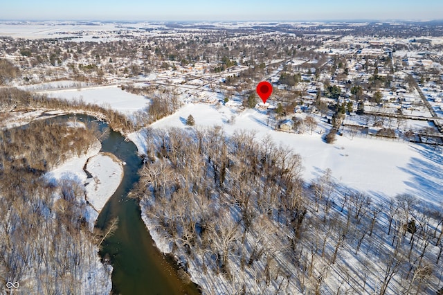 snowy aerial view with a water view