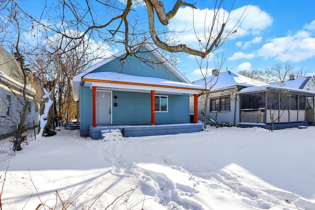 snow covered property featuring covered porch