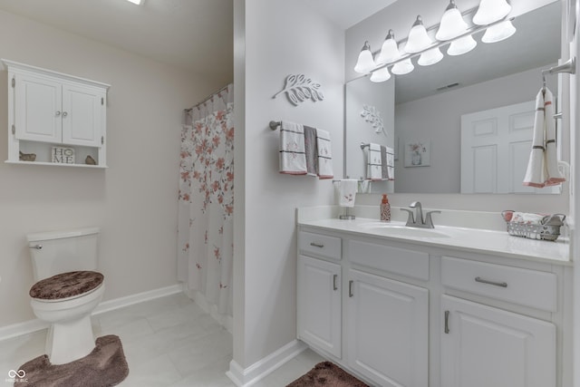 bathroom featuring curtained shower, vanity, and toilet