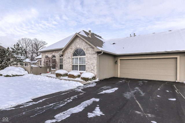 ranch-style home featuring a garage