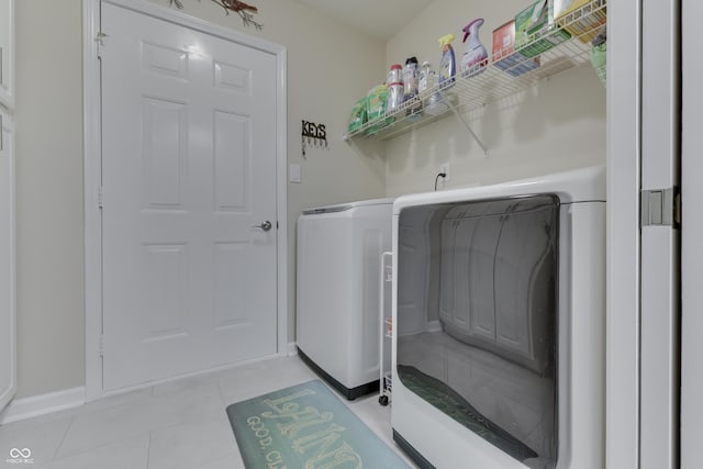 laundry area featuring light tile patterned floors