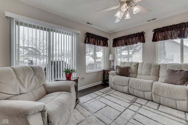 living room with hardwood / wood-style floors, plenty of natural light, and ceiling fan