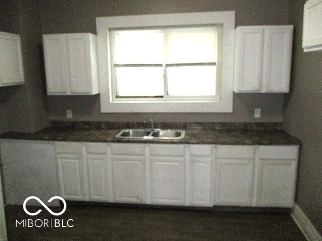 kitchen featuring sink and white cabinets