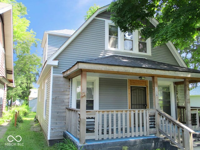 1138 W 33rd St, Indianapolis, IN 46208 - view of front facade with covered porch, a shingled roof, and a gambrel roof