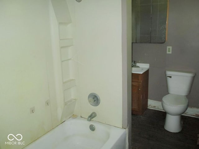 1138 W 33rd St, Indianapolis, IN 46208 - bathroom with vanity, toilet, shower / washtub combination, and wood finished floors