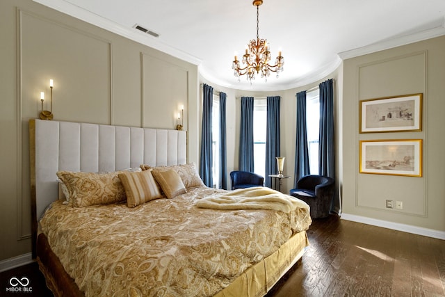 bedroom featuring crown molding, dark hardwood / wood-style floors, and an inviting chandelier