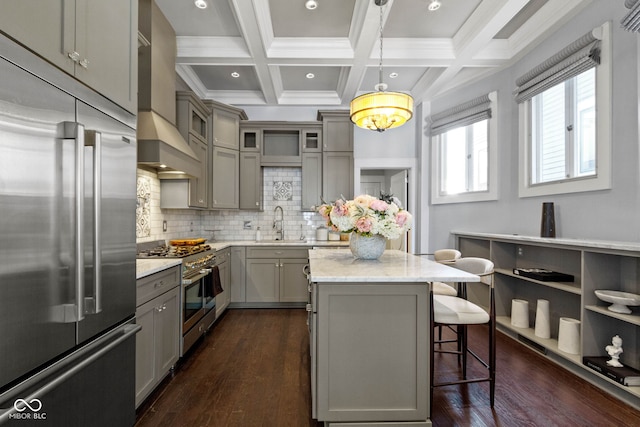 kitchen featuring light stone countertops, hanging light fixtures, premium appliances, beamed ceiling, and gray cabinets