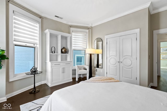 bedroom featuring dark hardwood / wood-style flooring, a closet, and crown molding