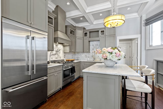 kitchen with premium range hood, gray cabinetry, coffered ceiling, high quality appliances, and beamed ceiling