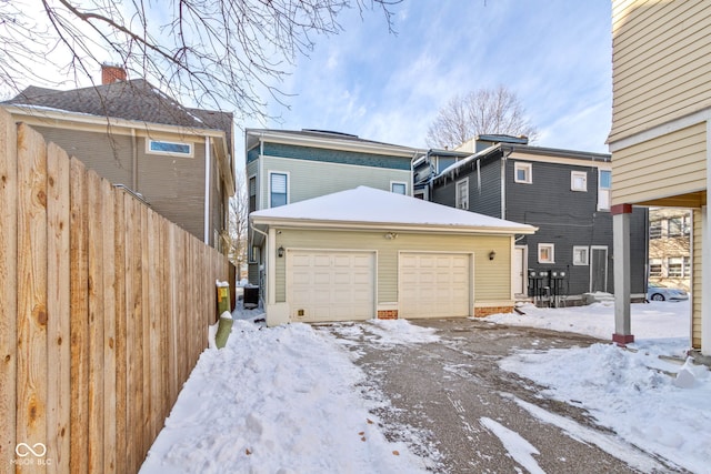 view of front facade featuring central AC, an outbuilding, and a garage