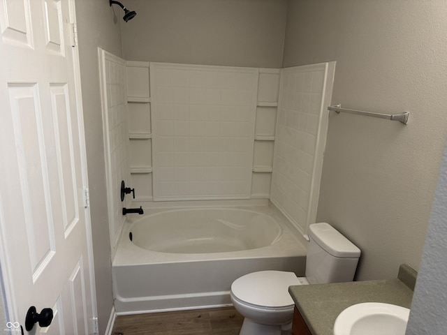 full bathroom with hardwood / wood-style flooring, vanity, bathtub / shower combination, and toilet