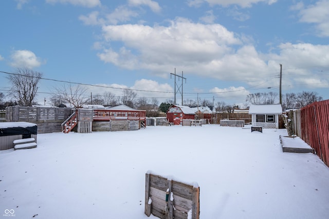 snowy yard with a shed